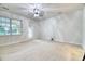 Bright, open living room with white walls, wood floors, ceiling fan, and a door to the outside at 149 Woodward Rd, Goose Creek, SC 29445