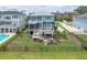 A beautifully landscaped backyard featuring a spacious deck, an outdoor seating area, and lush green grass at 1597 Rivertowne Country Club Dr, Mount Pleasant, SC 29466
