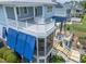 Multi-level decks with an outdoor kitchen, seating areas, and a screened-in porch offering stunning views at 1597 Rivertowne Country Club Dr, Mount Pleasant, SC 29466