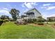 Expansive backyard featuring lush landscaping, a spacious lawn, and manicured garden beds at 1597 Rivertowne Country Club Dr, Mount Pleasant, SC 29466