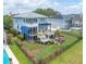Spacious fenced backyard featuring multi-level decks, a pergola, and a fire pit area for outdoor entertaining at 1597 Rivertowne Country Club Dr, Mount Pleasant, SC 29466