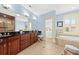 This bathroom has a granite-top vanity, a soaking tub with jets, and a glass shower, for a modern and spa-like feel at 1597 Rivertowne Country Club Dr, Mount Pleasant, SC 29466