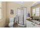A neutral bathroom features a vanity with granite countertop and an enclosed shower with a glass door at 1597 Rivertowne Country Club Dr, Mount Pleasant, SC 29466
