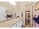 Bright bathroom with a large mirror, marble countertop and a shower with a floral curtain at 1597 Rivertowne Country Club Dr, Mount Pleasant, SC 29466