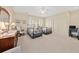 Bright bedroom featuring twin beds, neutral walls, ceiling fan, and closet space at 1597 Rivertowne Country Club Dr, Mount Pleasant, SC 29466