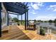 Spacious outdoor deck overlooking the lake with a built-in grill and pergola at 1597 Rivertowne Country Club Dr, Mount Pleasant, SC 29466