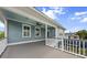 An outside second story deck with a ceiling fan and beautiful light blue accents offers relaxation and great lake views at 1597 Rivertowne Country Club Dr, Mount Pleasant, SC 29466