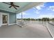 A covered deck with great lake views, ceiling fan and white railing provides ample outdoor living space at 1597 Rivertowne Country Club Dr, Mount Pleasant, SC 29466