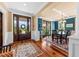 Elegant dining room with hardwood floors, a large table, and access to the porch through glass doors at 1597 Rivertowne Country Club Dr, Mount Pleasant, SC 29466