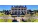 Stately community clubhouse boasts a grand entrance with columns, manicured grounds, and a welcoming atmosphere at 1597 Rivertowne Country Club Dr, Mount Pleasant, SC 29466
