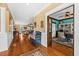 Warm and inviting entryway with hardwood floors, detailed trim, and a view into a stylish home office at 1597 Rivertowne Country Club Dr, Mount Pleasant, SC 29466