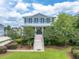 Beautiful two-story home with a welcoming front porch, attractive landscaping, and a grand staircase entrance at 1597 Rivertowne Country Club Dr, Mount Pleasant, SC 29466