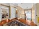 Bright hallway with hardwood floors, leading to bedrooms and stairs, offering a seamless transition at 1597 Rivertowne Country Club Dr, Mount Pleasant, SC 29466