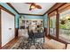 Bright home office with built-in bookshelves, a desk, and a view of the outdoors at 1597 Rivertowne Country Club Dr, Mount Pleasant, SC 29466