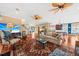 Bright and open living room featuring hardwood floors, ceiling fans and kitchen access, perfect for entertaining at 1597 Rivertowne Country Club Dr, Mount Pleasant, SC 29466
