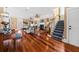 Spacious living room with hardwood floors, fireplace, and stairs, blending comfort and style at 1597 Rivertowne Country Club Dr, Mount Pleasant, SC 29466