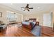 Spacious main bedroom featuring hardwood floors, tray ceiling, and sitting area, offering a relaxing retreat at 1597 Rivertowne Country Club Dr, Mount Pleasant, SC 29466