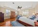 Serene main bedroom with tray ceiling, hardwood floors, and shuttered windows for natural light at 1597 Rivertowne Country Club Dr, Mount Pleasant, SC 29466