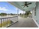 Covered porch overlooking a serene lake, providing a tranquil outdoor experience at 1597 Rivertowne Country Club Dr, Mount Pleasant, SC 29466