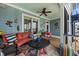 Relaxing outdoor porch featuring a comfy sofa, accent chairs, and decorative wall art at 1597 Rivertowne Country Club Dr, Mount Pleasant, SC 29466