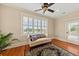 Bright sitting area with hardwood floors and a comfortable daybed, perfect for relaxation at 1597 Rivertowne Country Club Dr, Mount Pleasant, SC 29466