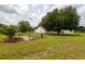 Spacious grassy backyard with a stone bench and landscaping, offering a peaceful outdoor space for relaxation at 160 Syrr Run Rd, Saint George, SC 29477