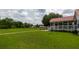 Backyard view with a screened-in porch and lush lawn at 160 Syrr Run Rd, Saint George, SC 29477