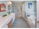 Bathroom featuring double vanity, shower, tub, decorative mirror, and accent lighting at 160 Syrr Run Rd, Saint George, SC 29477