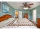 A spacious bedroom features wood floors, ceiling fan, quilt, and access to an ensuite and closet at 160 Syrr Run Rd, Saint George, SC 29477