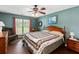 Inviting bedroom with ceiling fan, wood floors, natural light and a green armchair at 160 Syrr Run Rd, Saint George, SC 29477