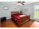 Bedroom with wood frame bed, ceiling fan, and natural light from the window at 160 Syrr Run Rd, Saint George, SC 29477