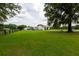 Spacious grassy yard with white single-story home, mature trees, fencing, and an RV, creating a welcoming exterior at 160 Syrr Run Rd, Saint George, SC 29477