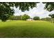 Expansive front yard with lush green grass and mature trees, providing a serene and inviting outdoor space at 160 Syrr Run Rd, Saint George, SC 29477