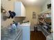 Functional laundry room and pantry space with white cabinets, shelving, and included washer and dryer at 160 Syrr Run Rd, Saint George, SC 29477