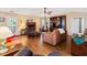 Cozy living room with a fireplace, comfortable leather furniture, and hardwood floors at 160 Syrr Run Rd, Saint George, SC 29477