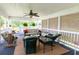 Relaxing screened-in porch with comfortable seating and ceiling fan, perfect for enjoying the outdoors at 160 Syrr Run Rd, Saint George, SC 29477