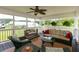 Inviting screened-in porch with comfortable seating, ceiling fan, and views of the backyard at 160 Syrr Run Rd, Saint George, SC 29477