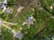 Aerial view of property with a pool and surrounding greenery within a red boundary line at 1604 Macoma Dr, Mount Pleasant, SC 29466
