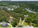 Aerial view of a home surrounded by lush greenery, with a red outline indicating property boundaries at 1604 Macoma Dr, Mount Pleasant, SC 29466