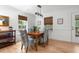 Dining room with hardwood floors, wooden table, blue upholstered chairs, and a modern light fixture at 1604 Macoma Dr, Mount Pleasant, SC 29466
