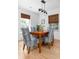 Close-up view of a dining room with hardwood floors, blue chairs, and a stylish light fixture at 1604 Macoma Dr, Mount Pleasant, SC 29466