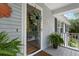 Up close, exterior view of front door with a wreath and home number above the covered porch at 1604 Macoma Dr, Mount Pleasant, SC 29466