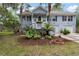 Charming two-story home with a well-manicured lawn, landscaped garden, and welcoming front porch at 1604 Macoma Dr, Mount Pleasant, SC 29466