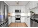 Well-lit kitchen boasts stainless steel appliances, white cabinets, subway tile backsplash, and sleek countertops at 1604 Macoma Dr, Mount Pleasant, SC 29466