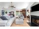 Cozy living room with hardwood floors, a fireplace, white couches, and stylish decor at 1604 Macoma Dr, Mount Pleasant, SC 29466