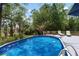 The backyard features a refreshing above-ground pool, and a deck surrounded by lush trees at 1604 Macoma Dr, Mount Pleasant, SC 29466