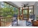Inviting screened porch featuring rocking chairs and a ceiling fan, perfect for relaxing outdoors at 1604 Macoma Dr, Mount Pleasant, SC 29466
