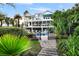 Multi-story home featuring a fenced pool area accessible via a brick pathway and lush green landscaping at 1635 Bull Creek Ln, Charleston, SC 29414