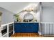 The wet bar features blue cabinets, a marble countertop, and a round mirror at 1635 Bull Creek Ln, Charleston, SC 29414