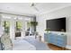Bright bedroom features a comfortable king bed, accent chair and large TV with hardwood flooring at 1635 Bull Creek Ln, Charleston, SC 29414